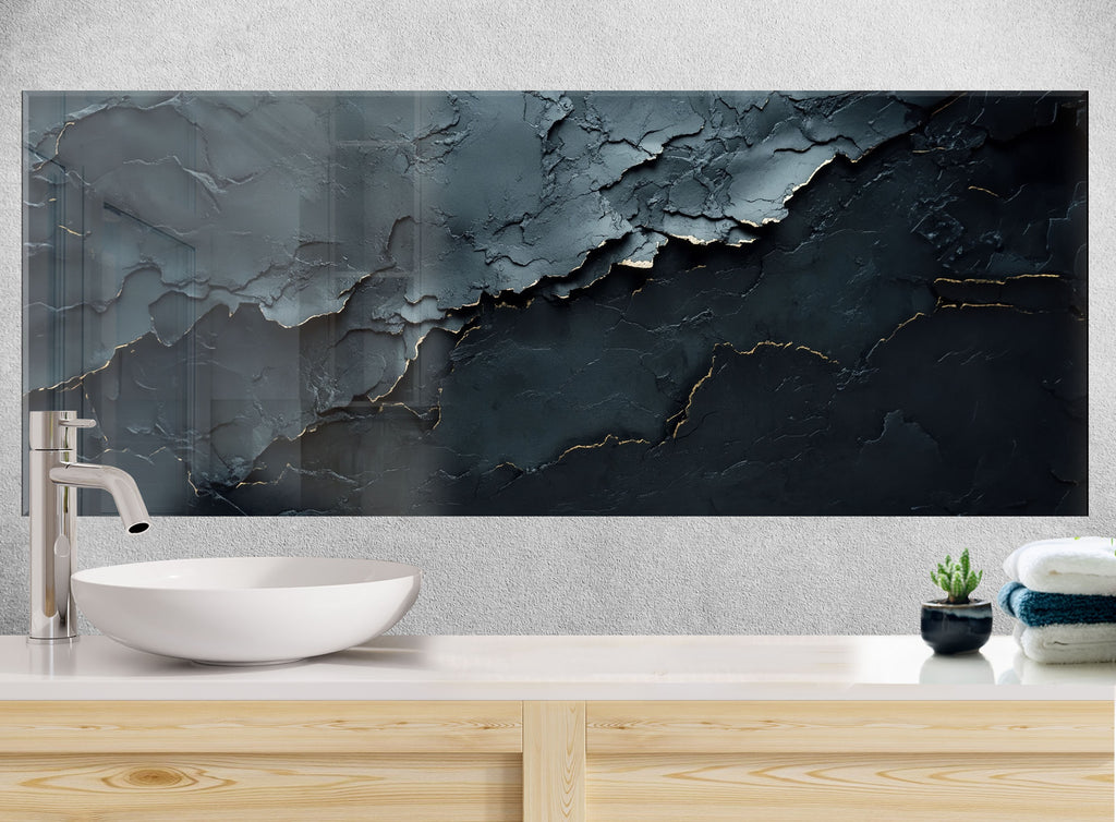 Modern artistic backsplash glass with deep black marble effect and shimmering gold lines, a statement piece for luxury kitchens.

