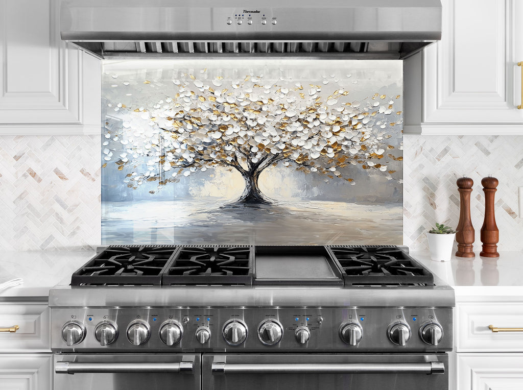 Modern kitchen glass backsplash featuring a radiant white and gold tree for artistic impact.

