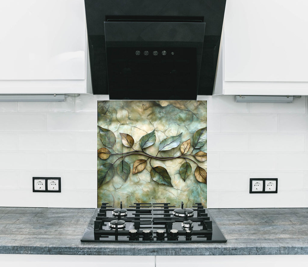 Elegant kitchen backsplash glass art with artistic green leaves motif, ideal for earthy, serene, and stylish decor.

