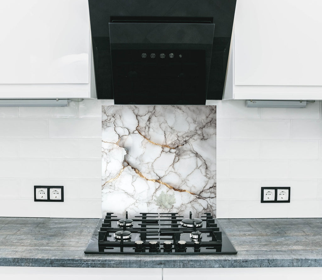 Elegant marble effect backsplash glass with shimmering gold accents ideal for modern kitchens.

