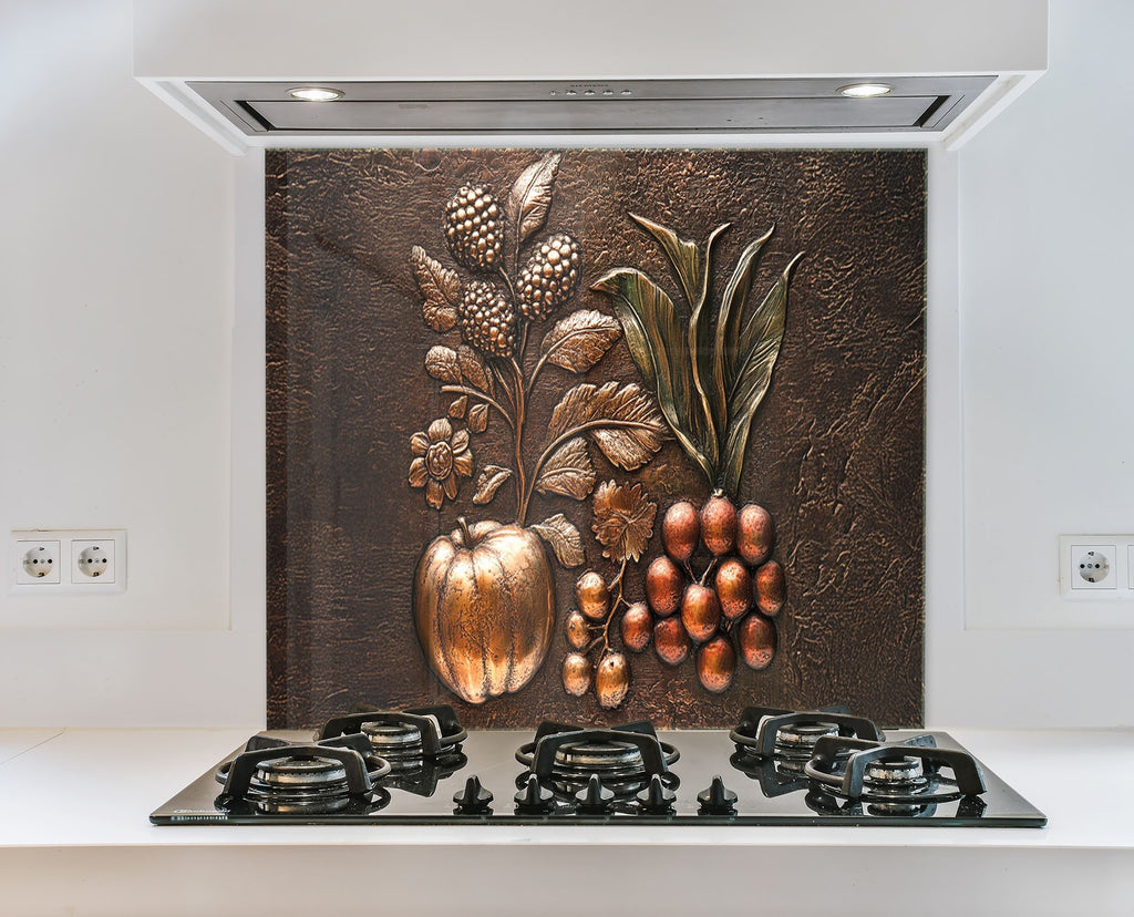 Vintage-style copper embossed fruit design on glass backsplash – warm and textured kitchen accent.

