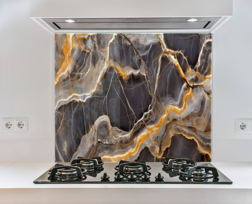 Dark marble effect glass kitchen backsplash with striking amber and gold veins.


