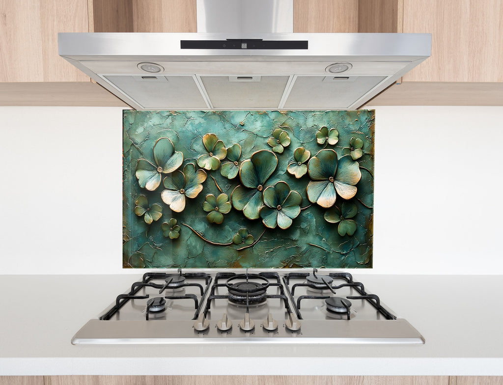 Green floral themed glass kitchen backsplash with golden outline textures – stylish and serene.

