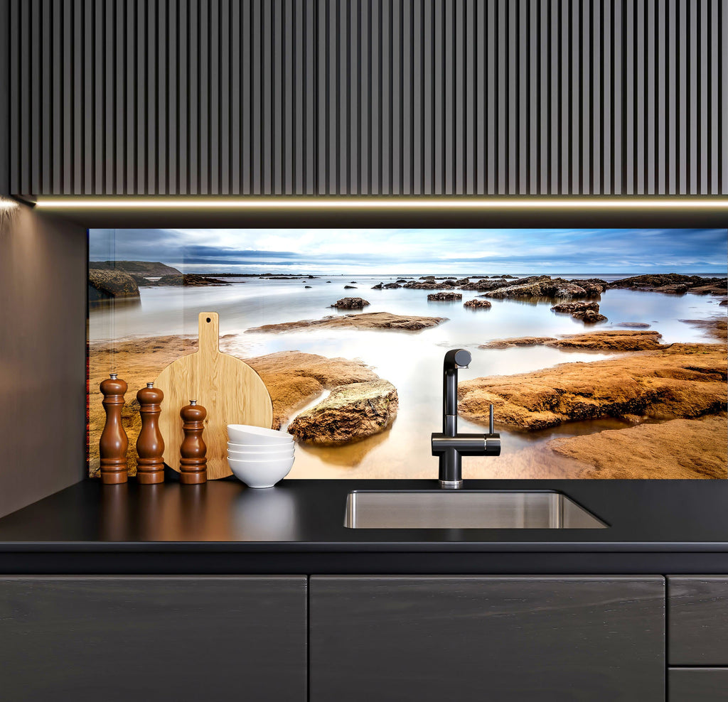 a kitchen with a sink and a painting on the wall