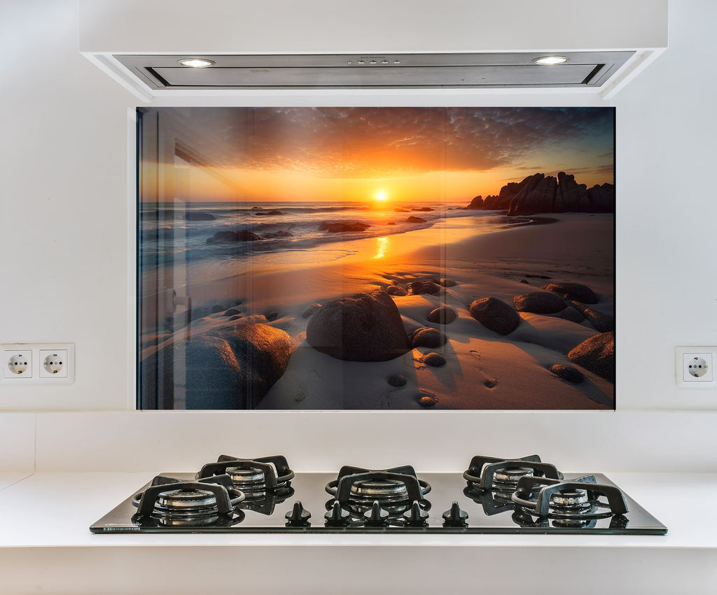 a picture of a sunset over a beach with rocks