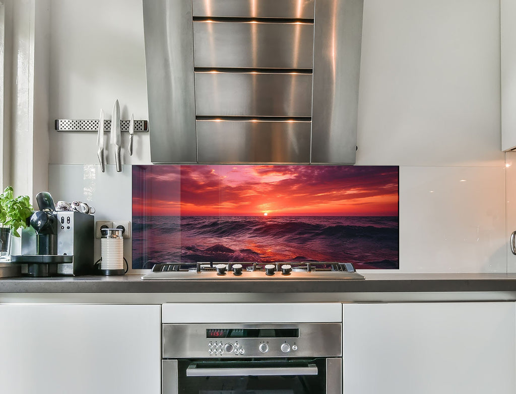 a kitchen with stainless steel appliances and a picture on the wall