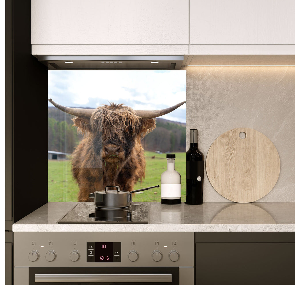 a cow standing in a kitchen next to a stove top oven