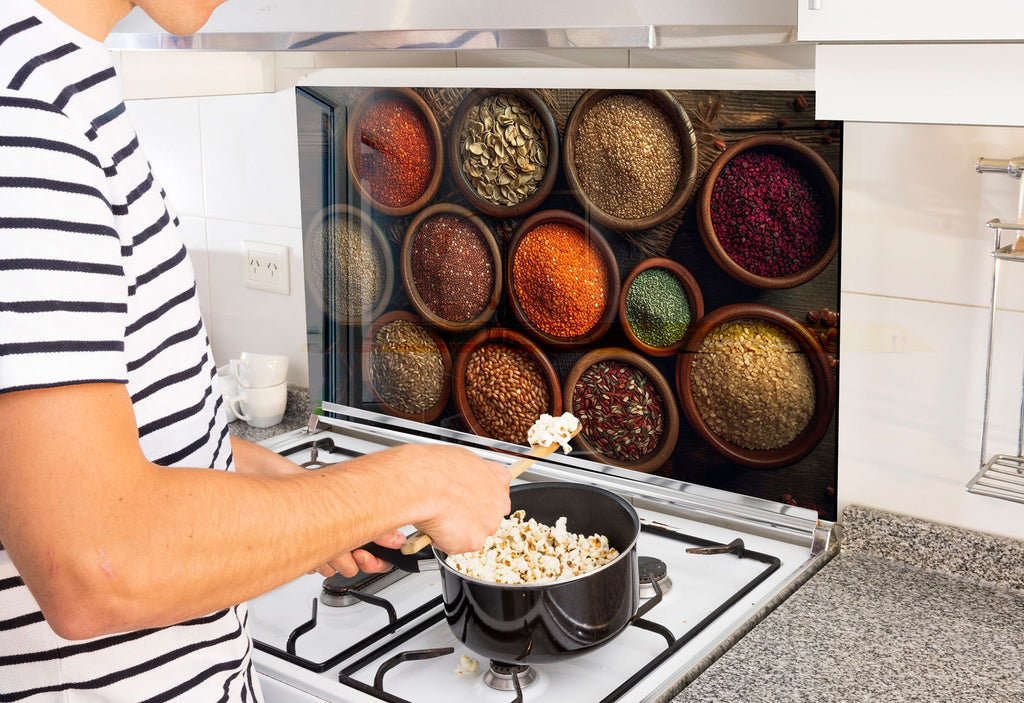 a man cooking food in a pot on the stove